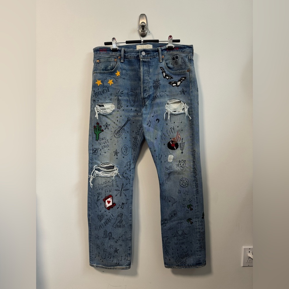 Blue Distressed Jeans with Embroidered Patches